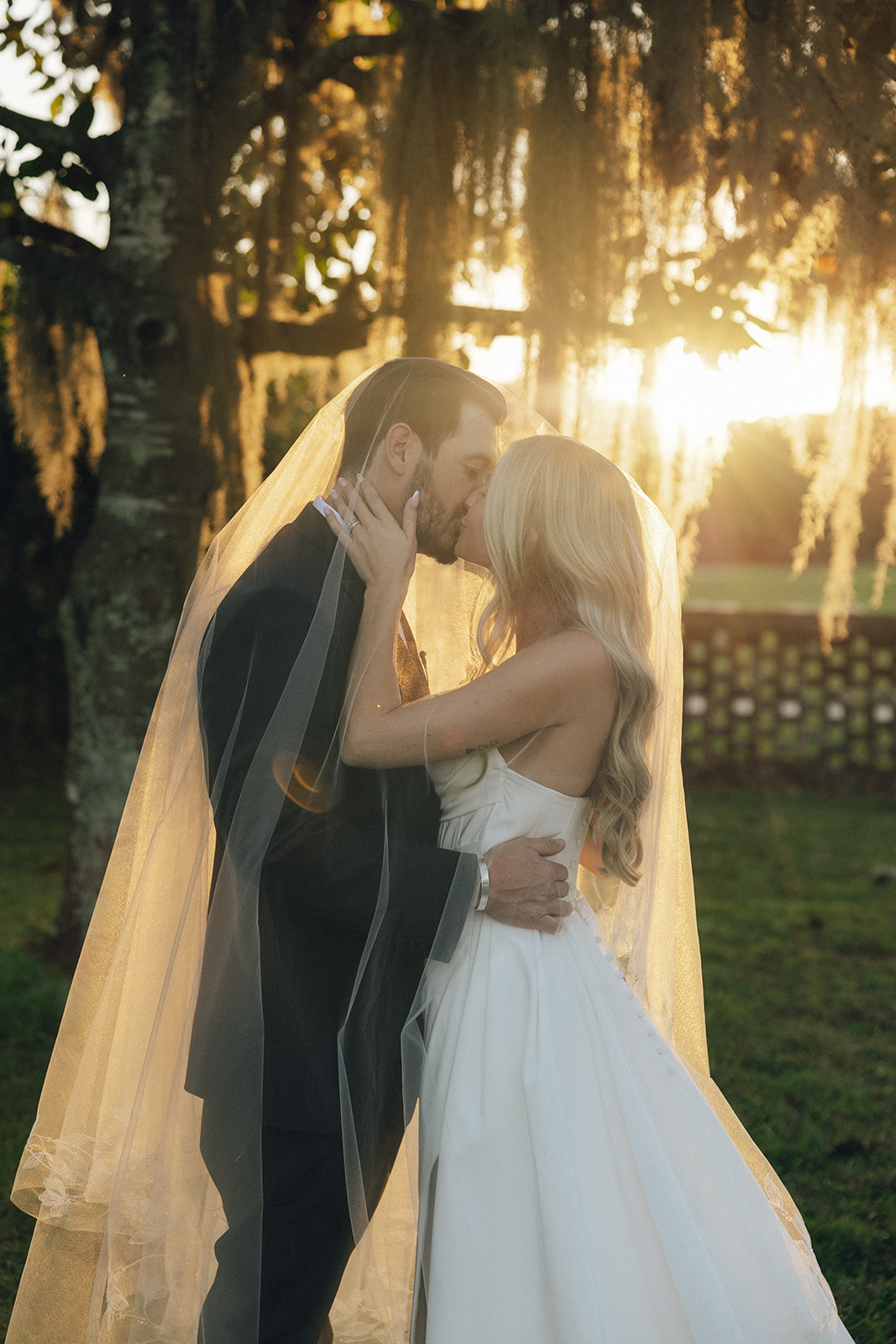 A bride and groom share a kiss during golden hour portraits with G&M Visions.