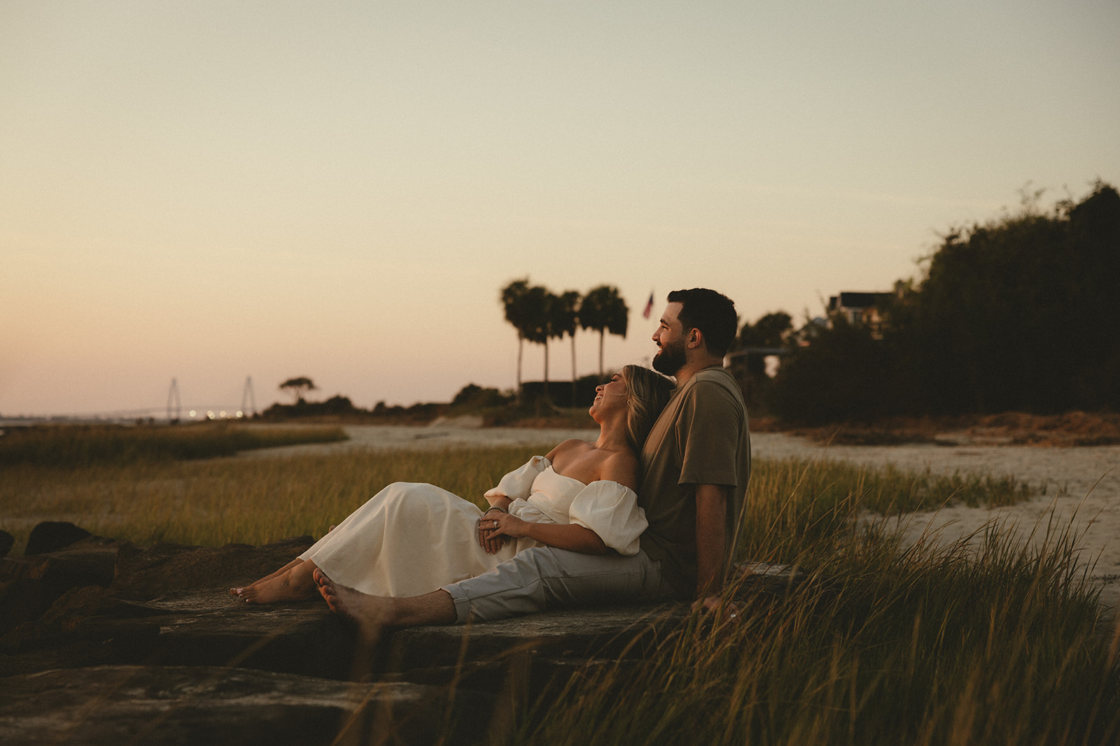 A couple on the beach at Sullivan's Island in South Carolina posing for their engagement photos.