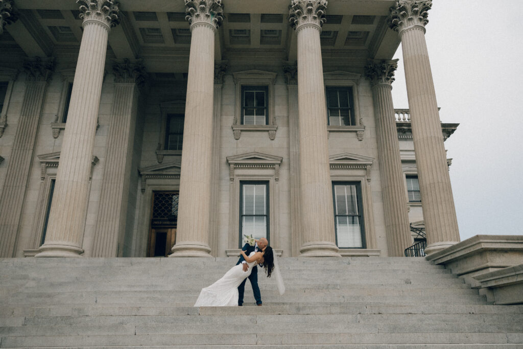 A bride and groom share a kiss in downtown Charleston, SC.