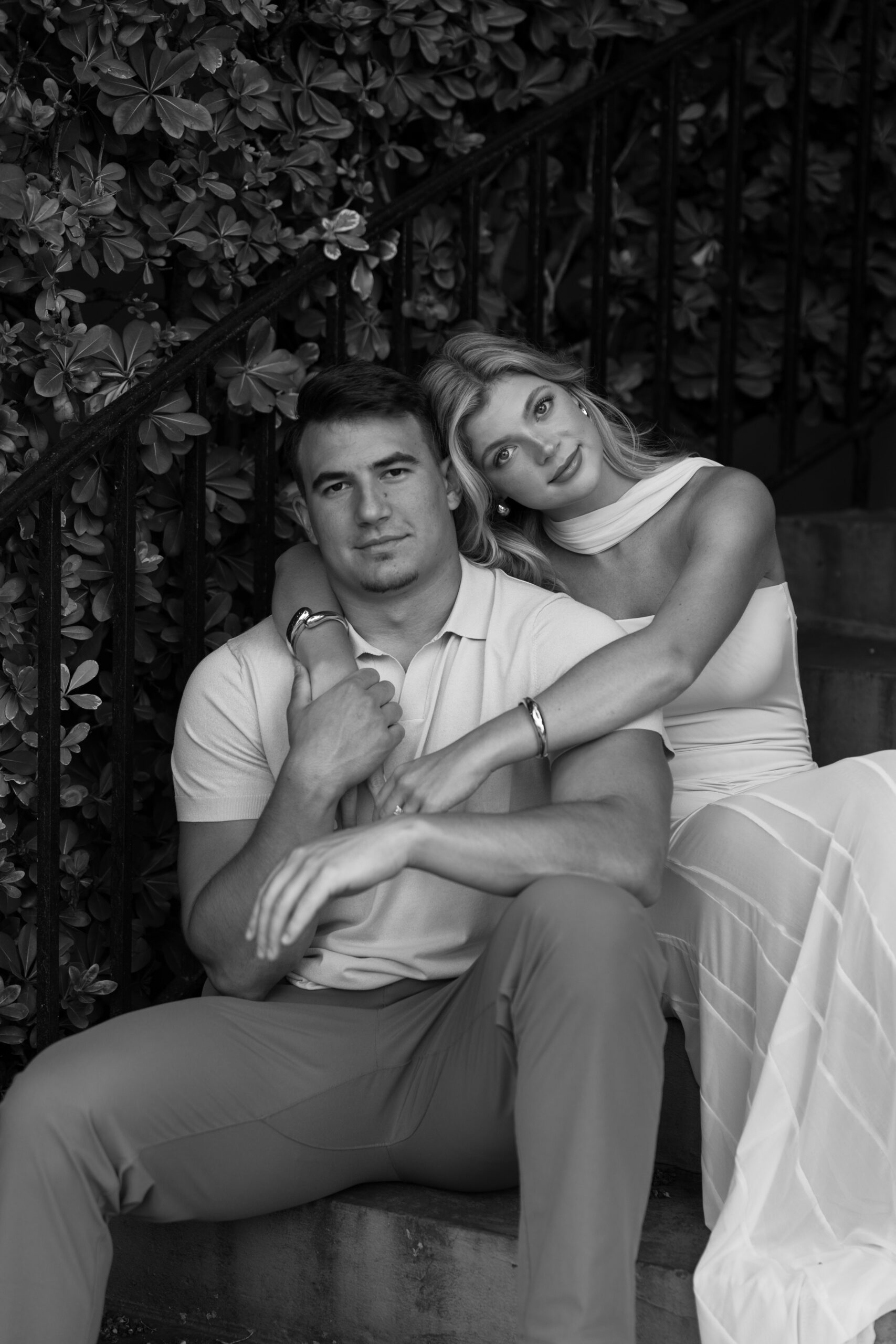 An engaged couple posing for a photo in downtown Charleston, SC.