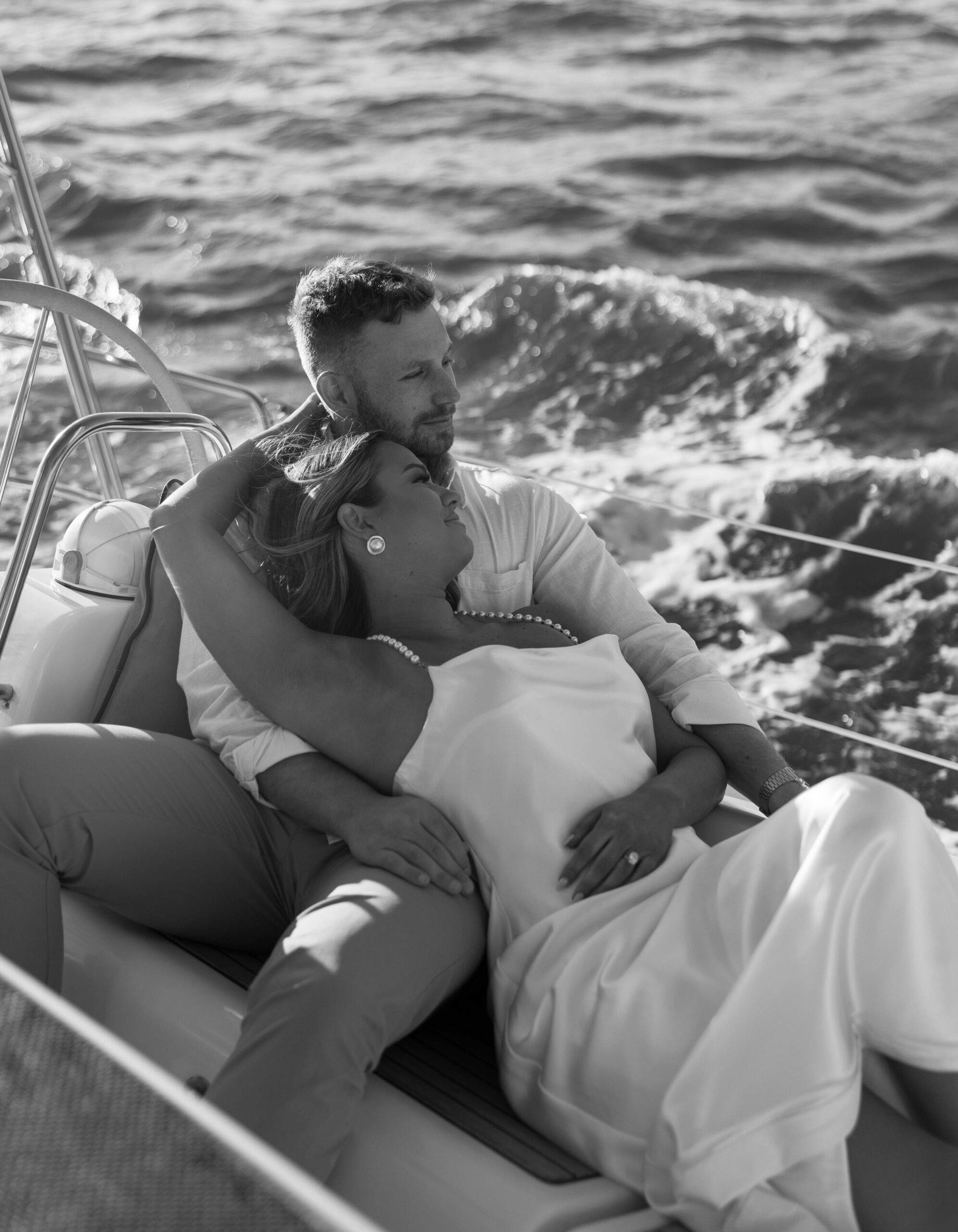 A couple poses on a boat in Charleston, SC for their engagement photos.