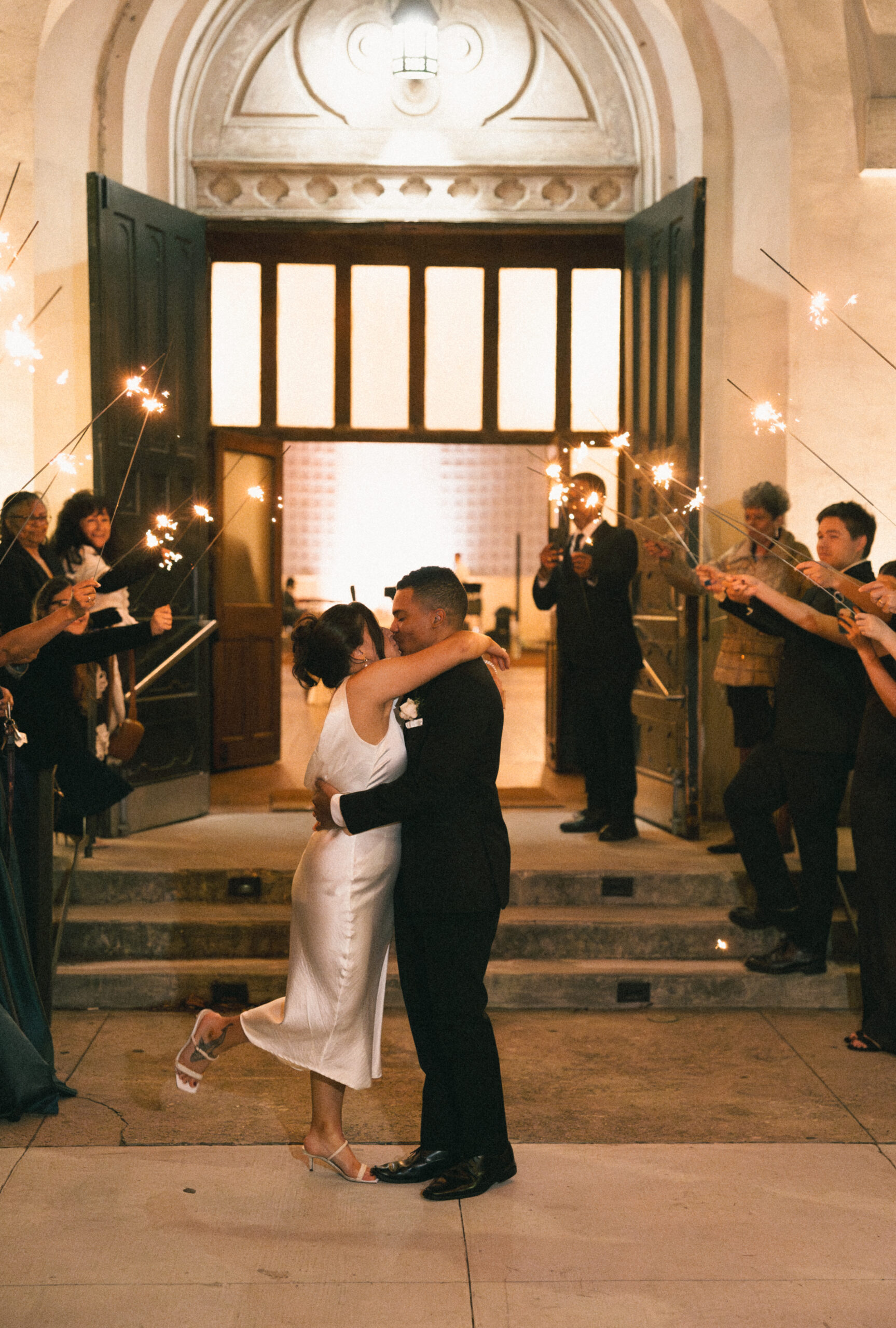 A bride and groom exit their Louisiana wedding with a sparkler sendoff.